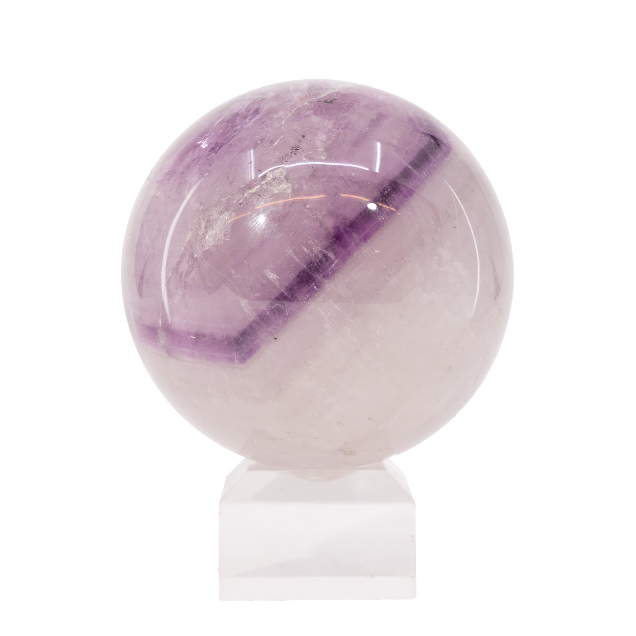 Amethyst crystal ball on a white stand with a white background