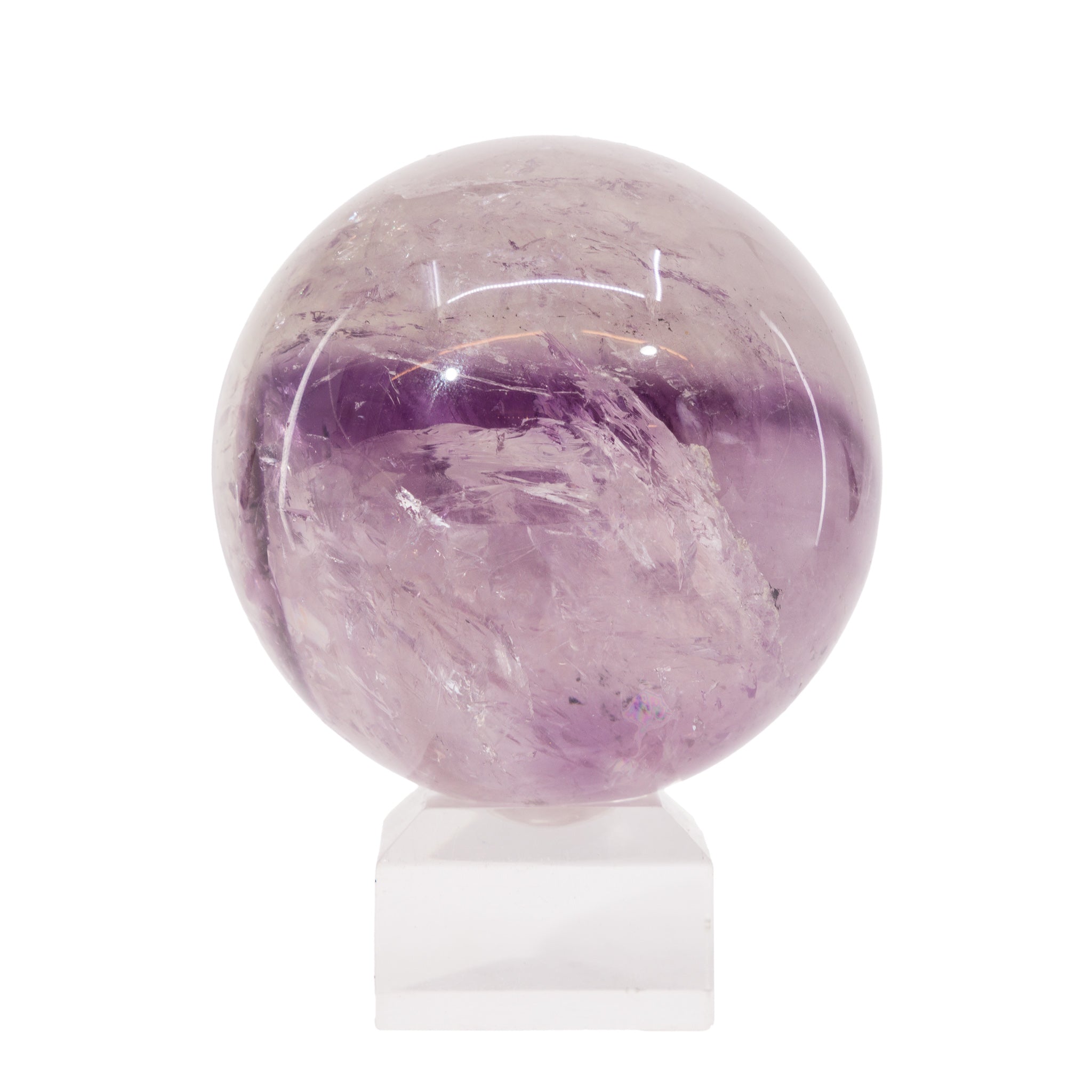 Amethyst crystal sphere on a white stand with a white background