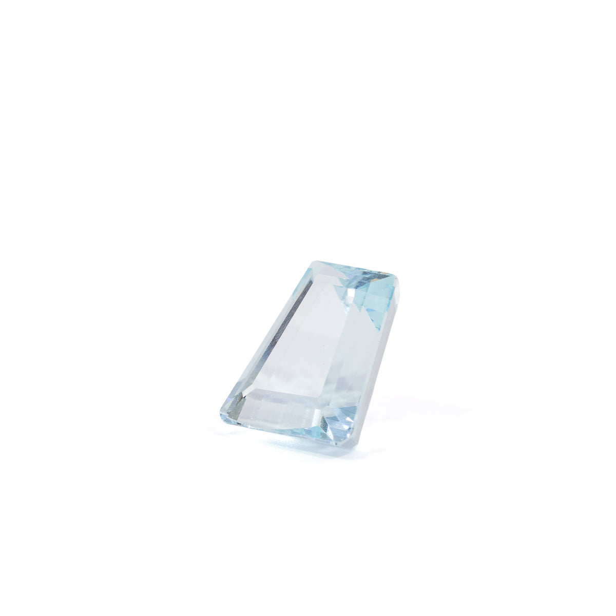 Elongated tapered step-cut Aquamarine gemstone, angled view