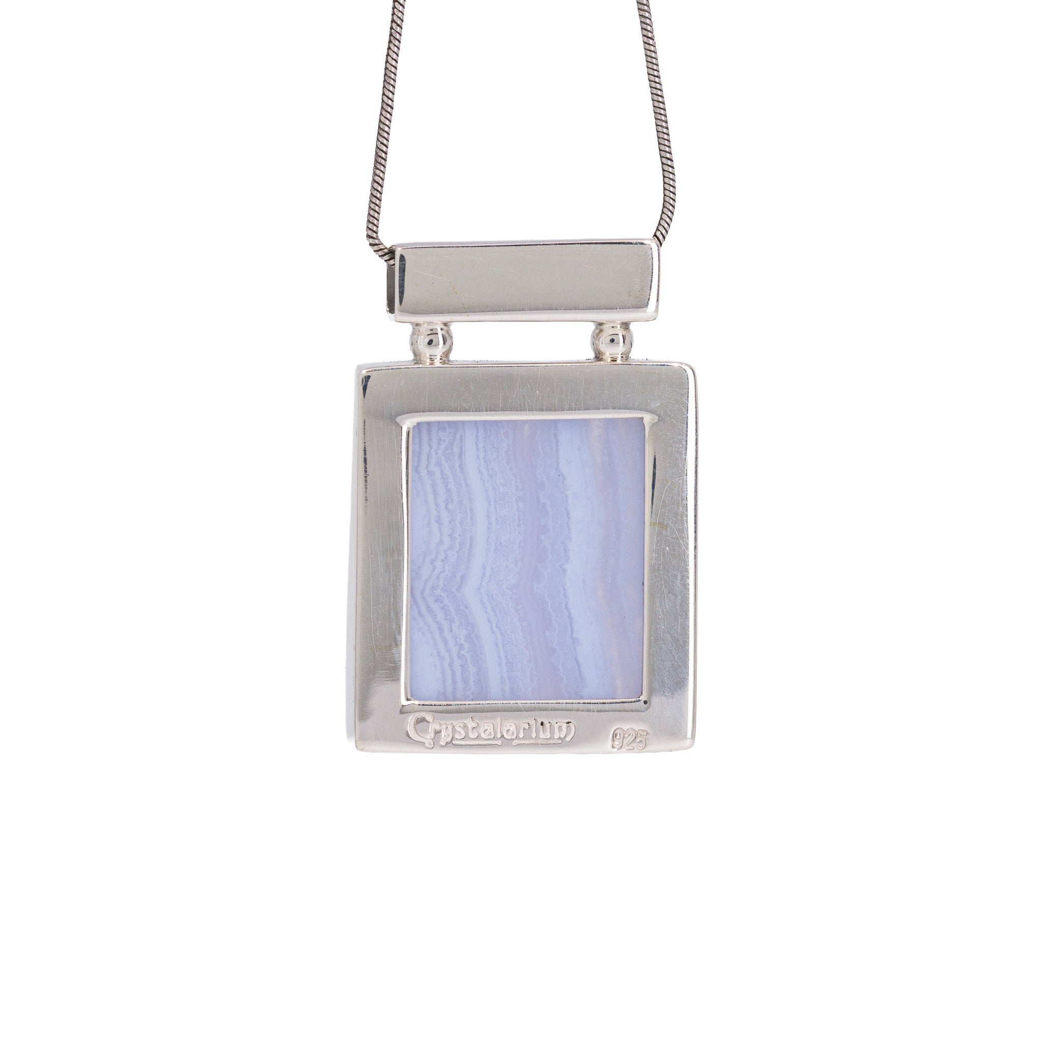 Reverse view of Blue Lace Agate pendant with Crystalarium hallmark