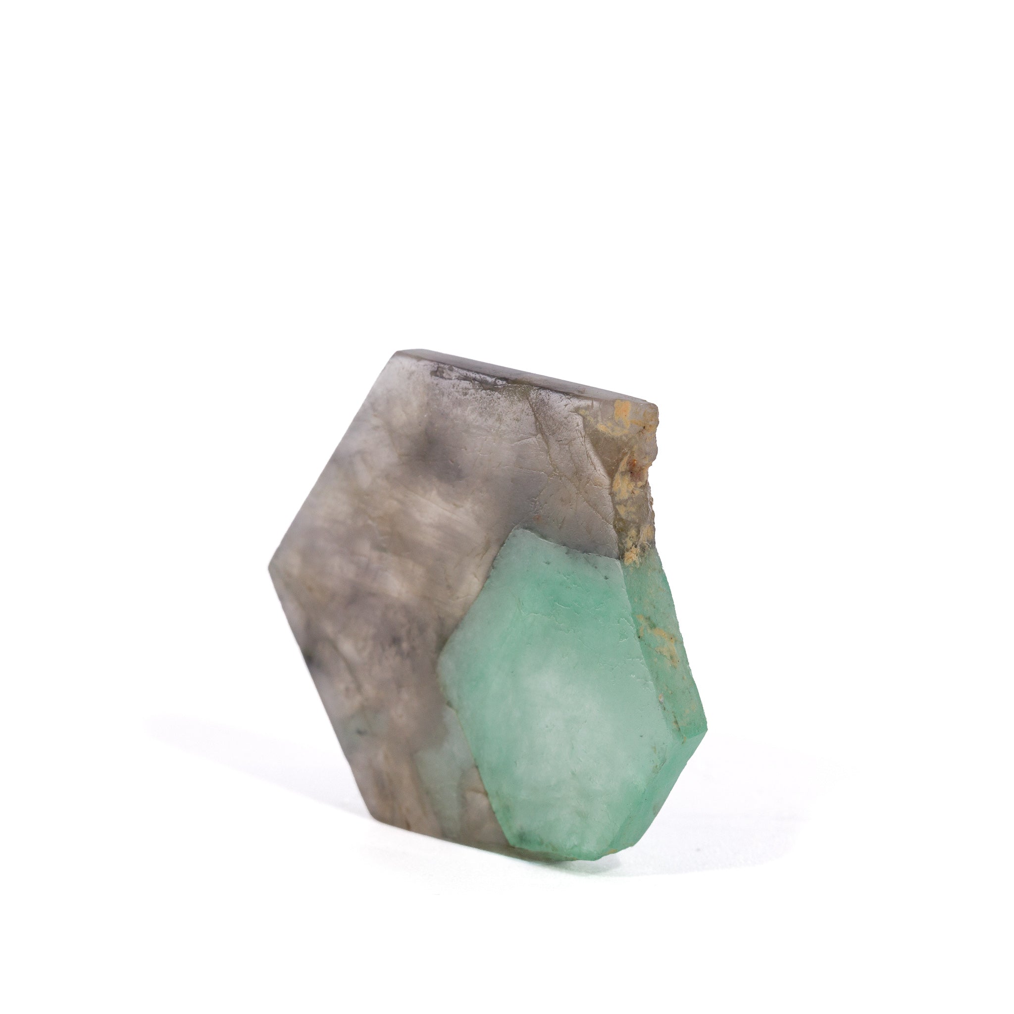 Angled view of Emerald in Smoky Quartz showing natural edge and color contrast