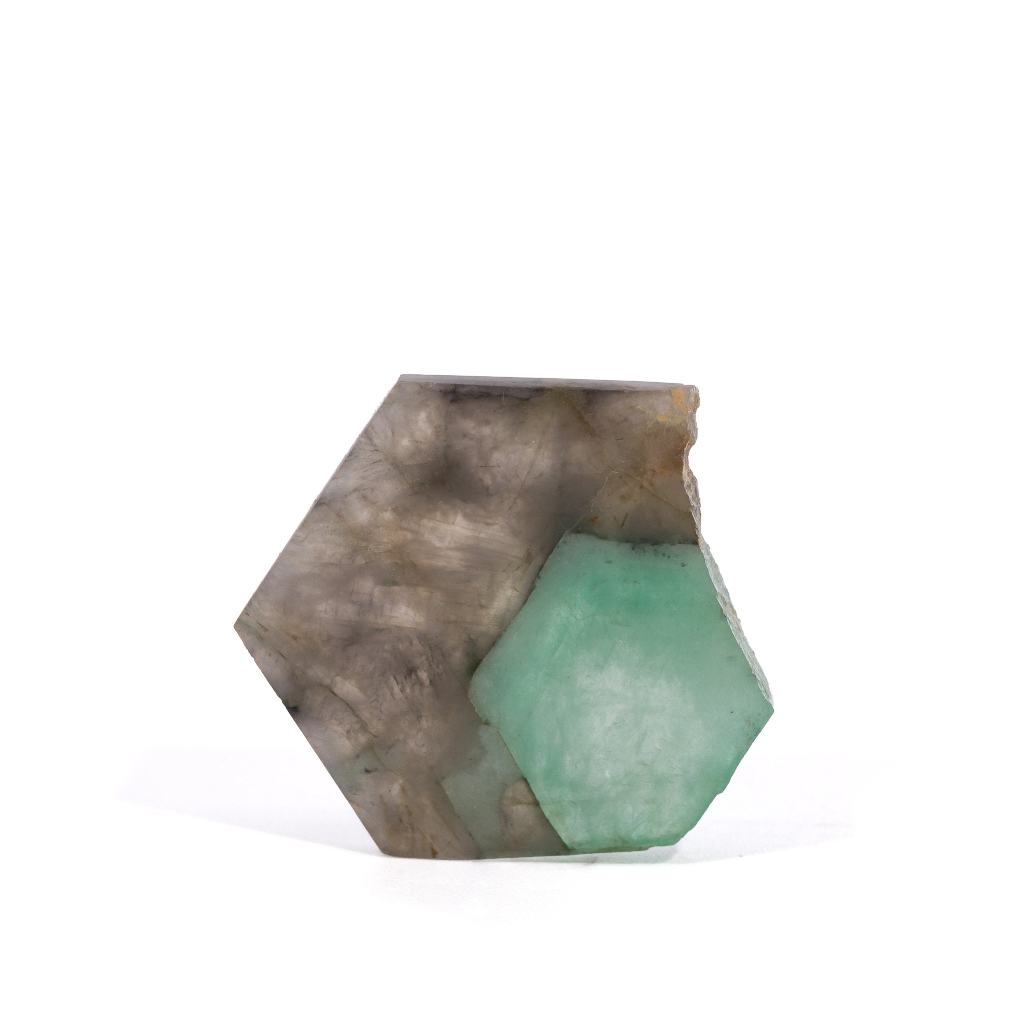 Front view of pale green Emerald crystal enclosed in polished Smoky Quartz