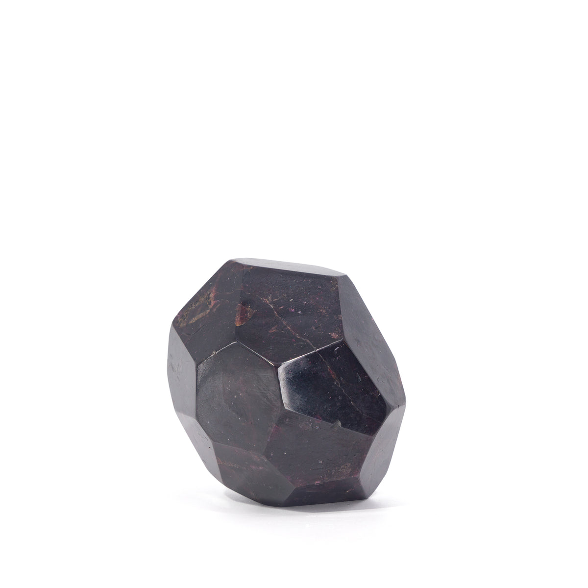 Angled view of faceted Garnet freeform showing deep red mineral markings