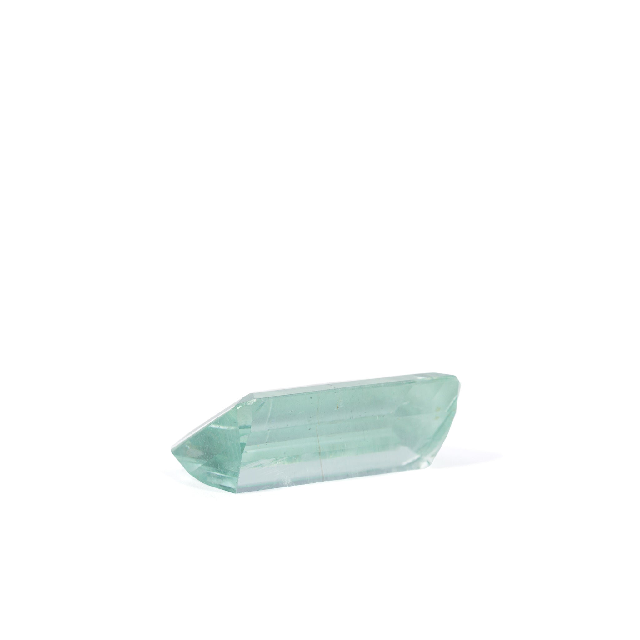 Side profile of elongated Green Beryl gemstone with pale aqua-green color