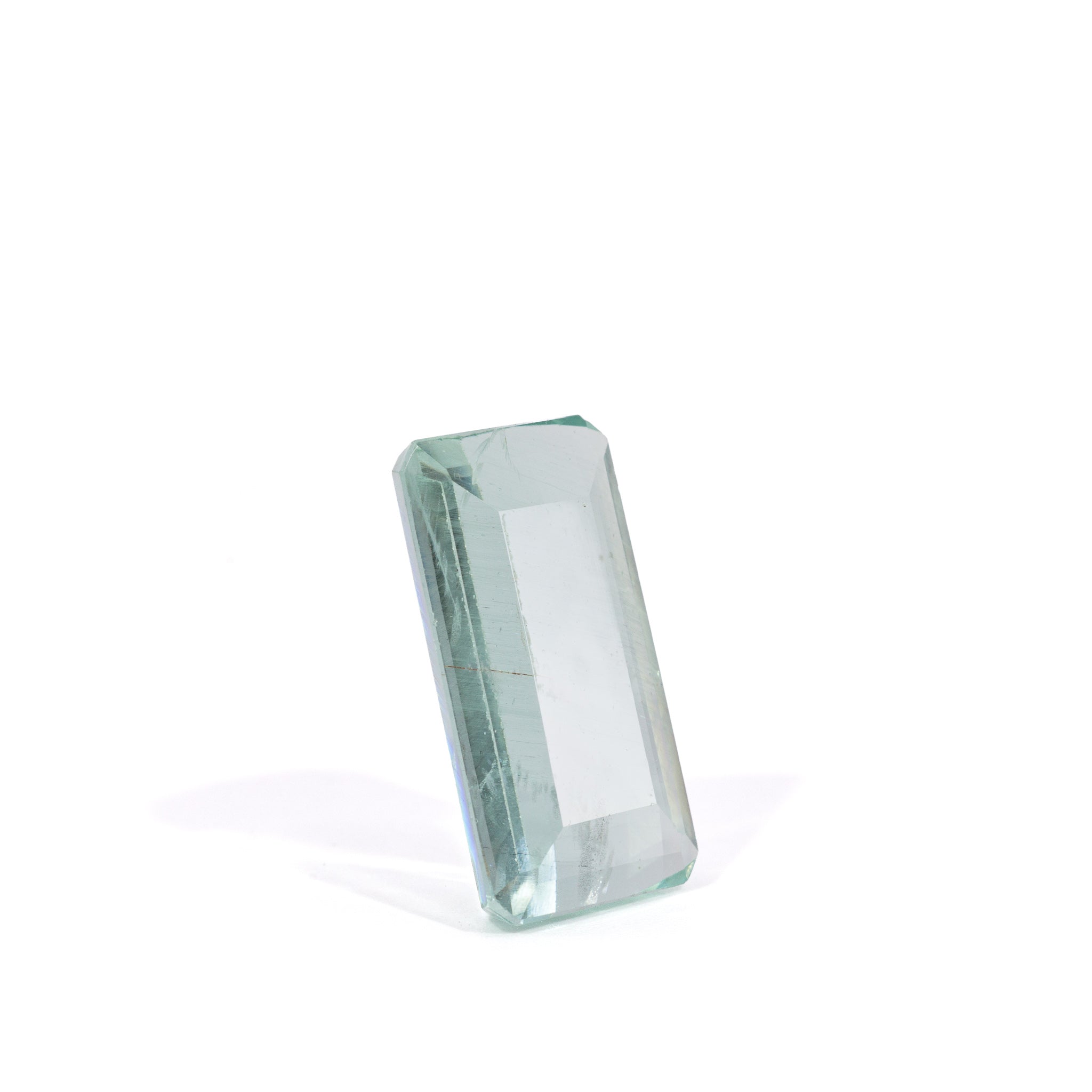 Upright view of pale green rectangular step-cut Beryl gemstone