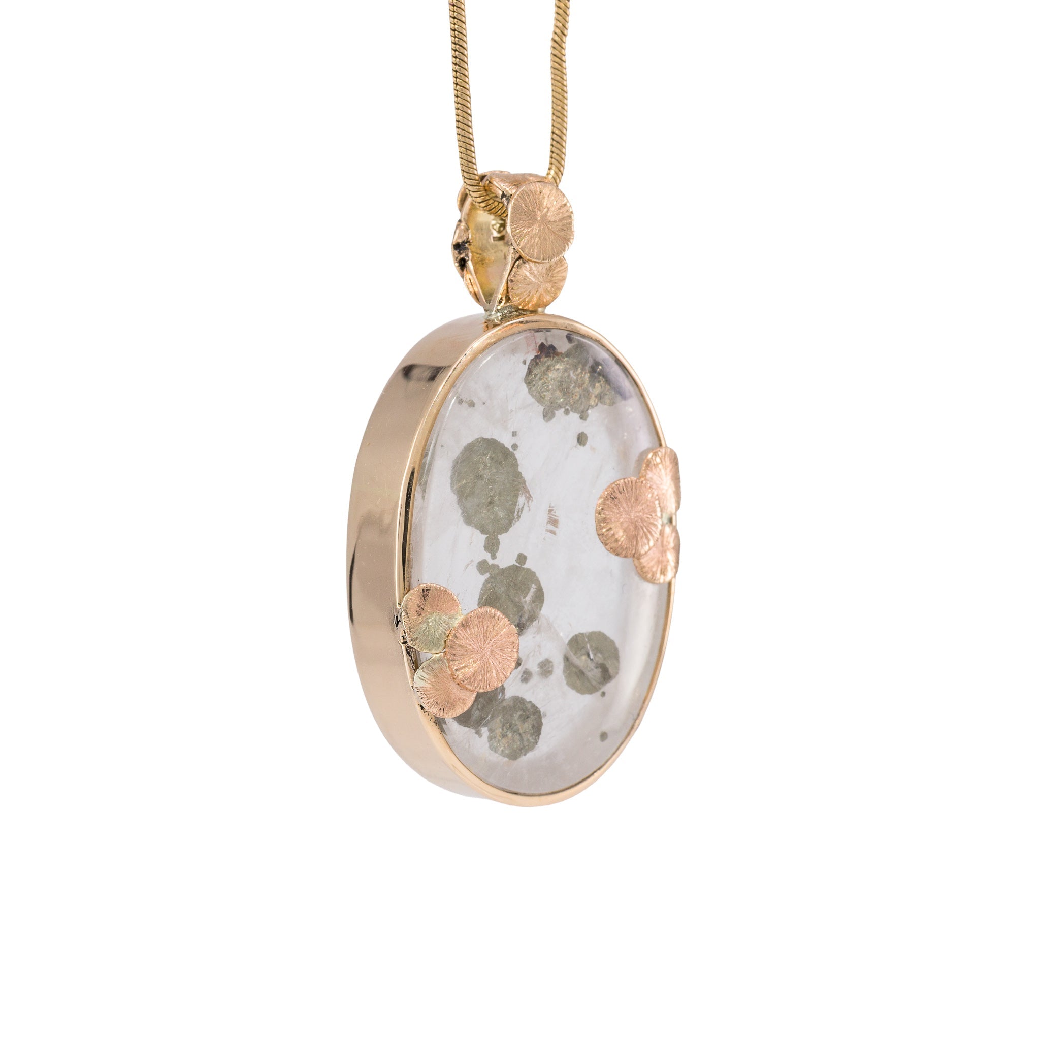 Opposite side view of oval Quartz pendant with metallic Marcasite Suns and gold details