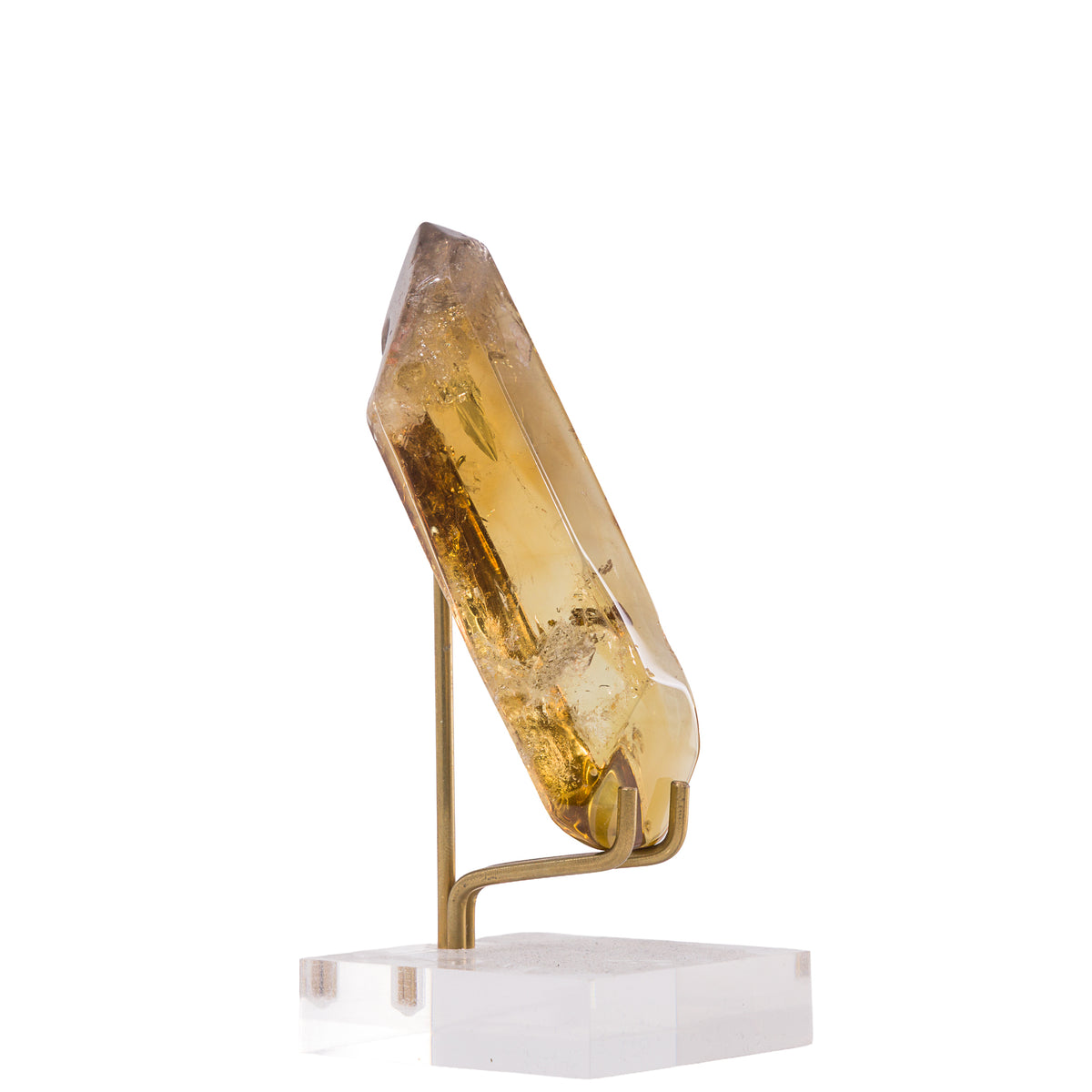 Side view of honey-gold Citrine point with internal veils