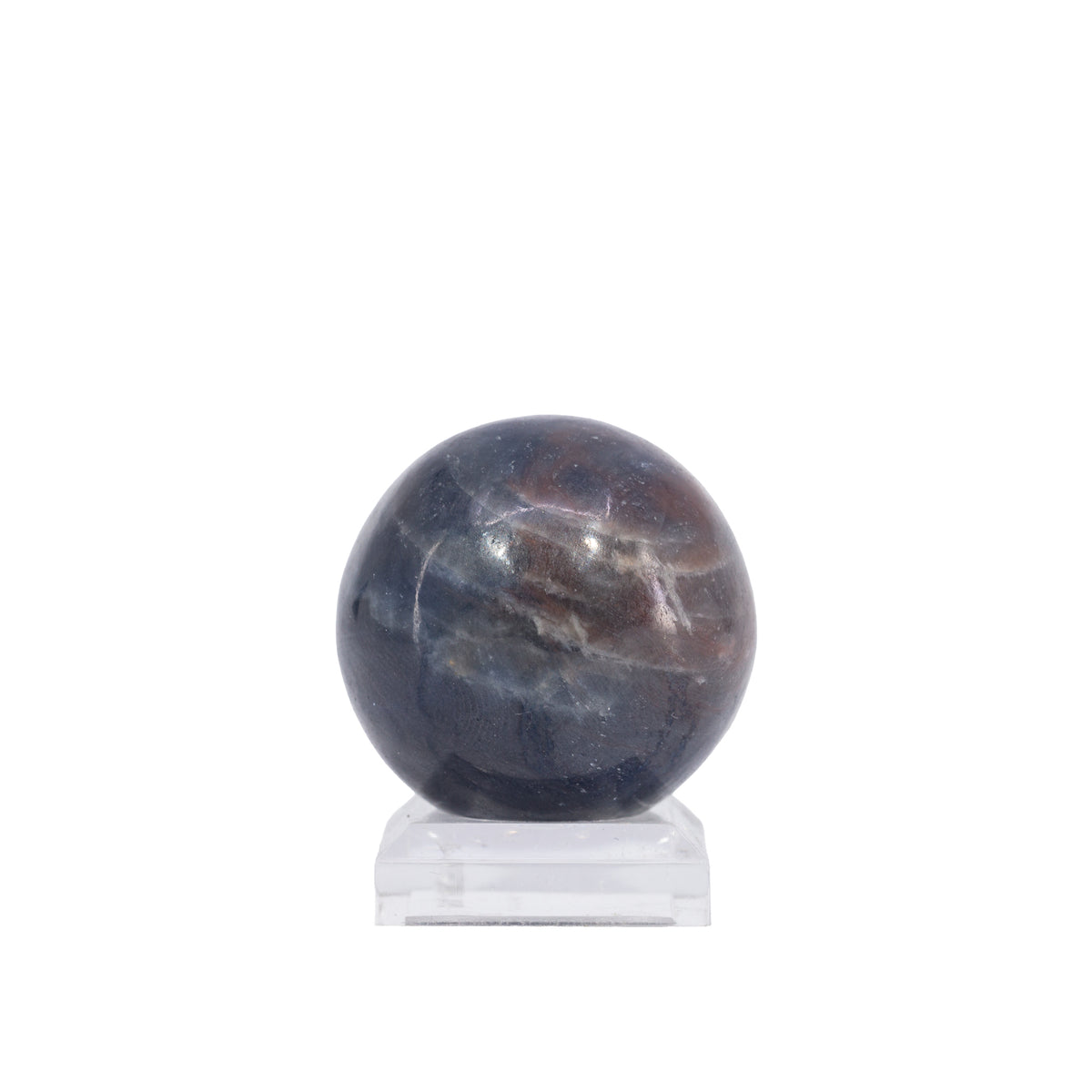Sapphire sphere showing smoky gray and burgundy-brown mineral patches