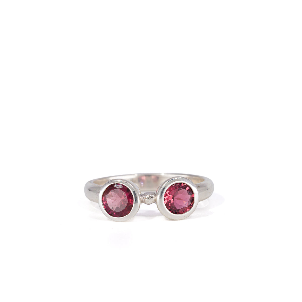 Front view of two raspberry-red Rhodolite Garnets in silver bezels