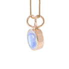 Angled view of 14K Moonstone charm pendant showing the substantial bezel and double-loop bail