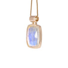 Side view of 14k gold Moonstone pendant showing bezel and blue flash