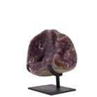 Wide Amethyst geode displayed on a black metal stand, angled view