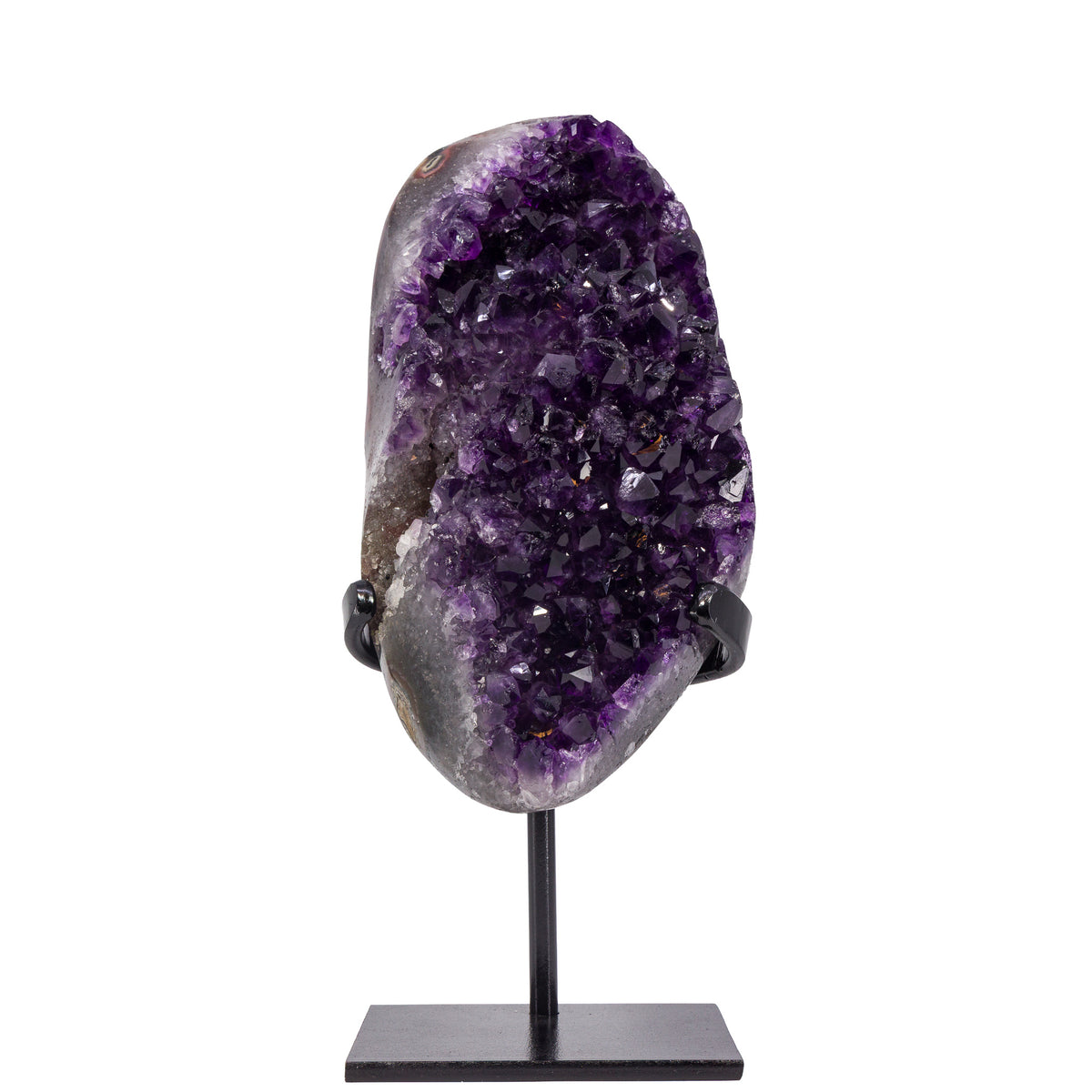 Deep purple Amethyst geode displayed on a black metal stand, front view