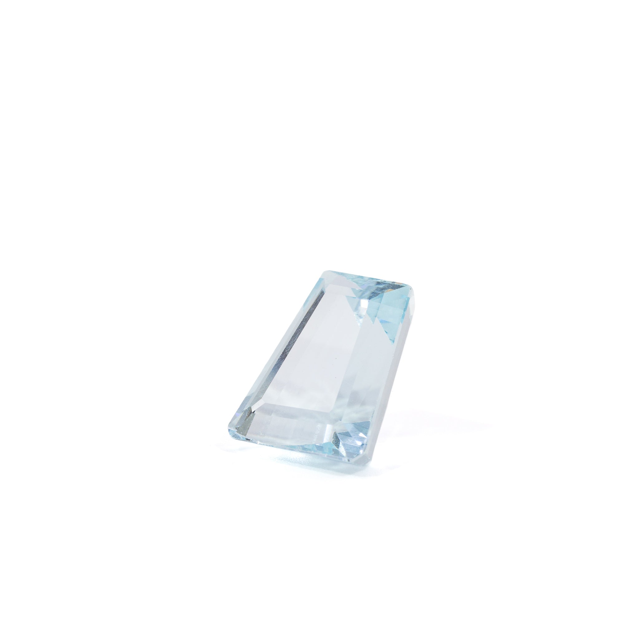 Elongated tapered step-cut Aquamarine gemstone, angled view