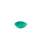 Side view of faceted Colombian Emerald showing its curved profile and clarity