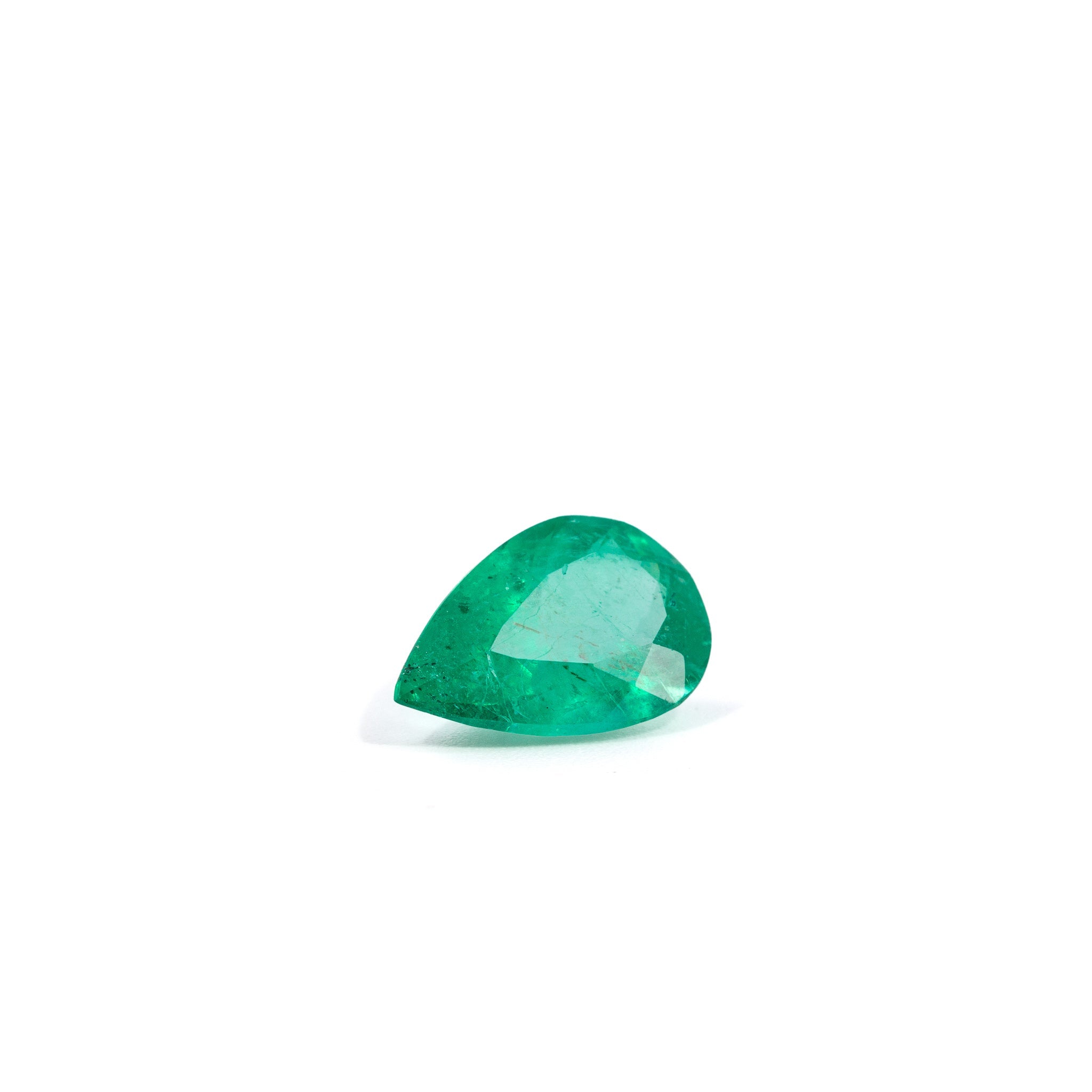 Front view of elongated pear-cut Colombian Emerald with vivid green color
