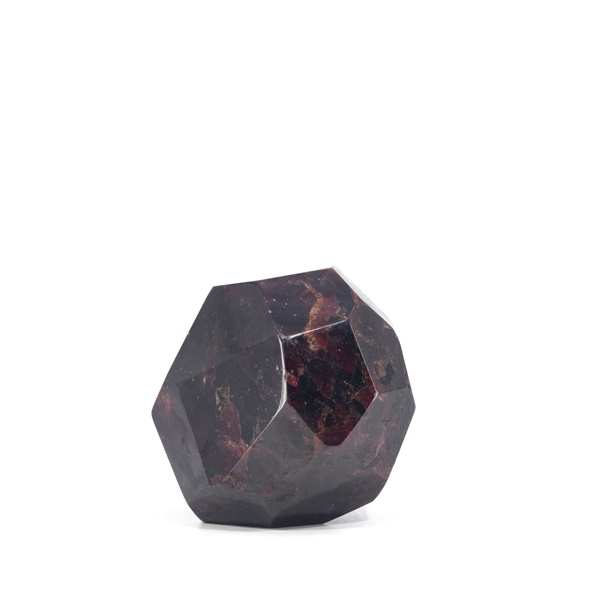 Side view of polished Garnet freeform with broad geometric facets