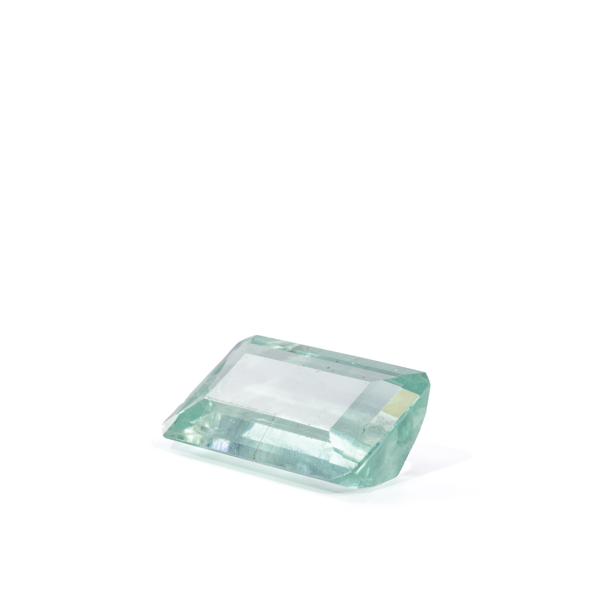 Three-quarter view of transparent Green Beryl showing its long step facets