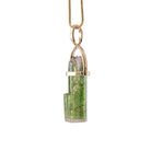 Side view of Green Tourmaline crystal pendant in open 14K setting
