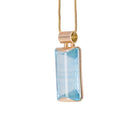 Side view of Natural Blue Topaz gemstone pendant in 14K