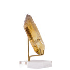 Side view of honey-gold Citrine point with internal veils