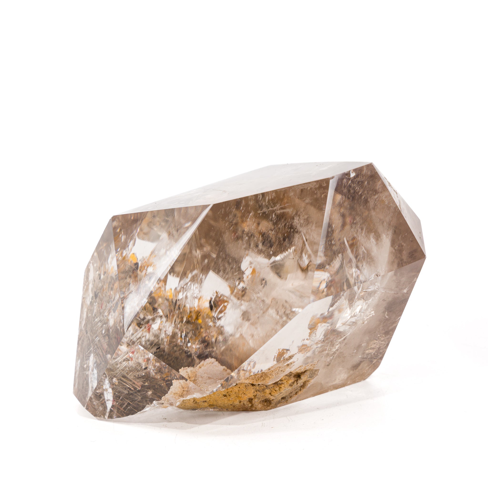 Side view of faceted Reticulated Rutilated Quartz point with natural matrix along the base