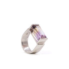 Angled view of emerald-cut Ametrine ring with wide sterling silver band