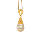 Angled view of Tahitian South Sea Pearl pendant and sculptural 22K bail